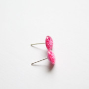 neon pink flower stud earrings side view