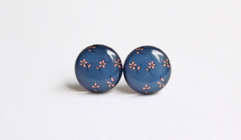 Stud earrings with nostalgic flowers on a dark blue background