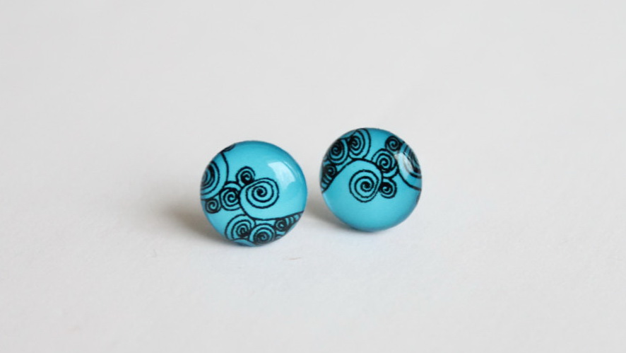 Blue studs with abstract swirls